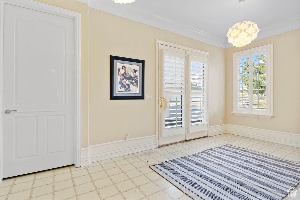 Unfurnished dining area featuring crown molding and tile patterned floors