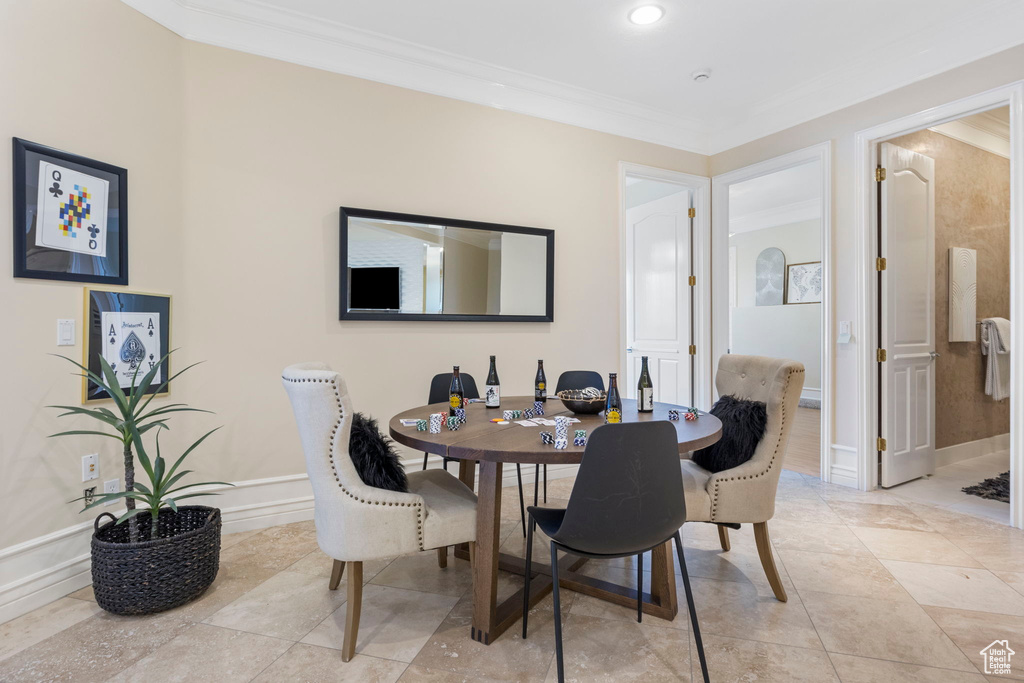 Dining room with ornamental molding and baseboards