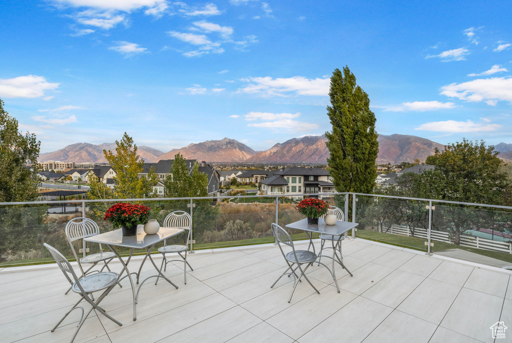 View of patio featuring a mountain view, a residential view, and a balcony