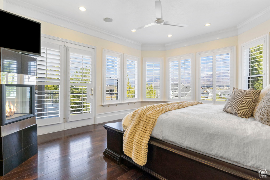 Bedroom featuring access to exterior, wood finished floors, crown molding, recessed lighting, and a ceiling fan