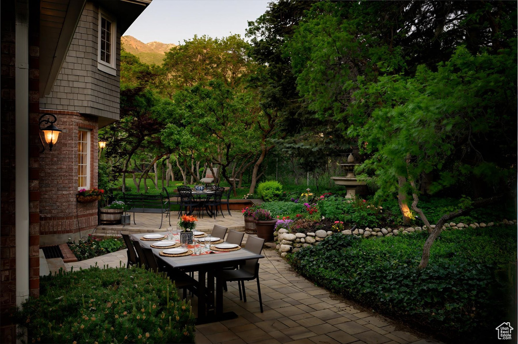 View of patio with outdoor dining space and a mountain view