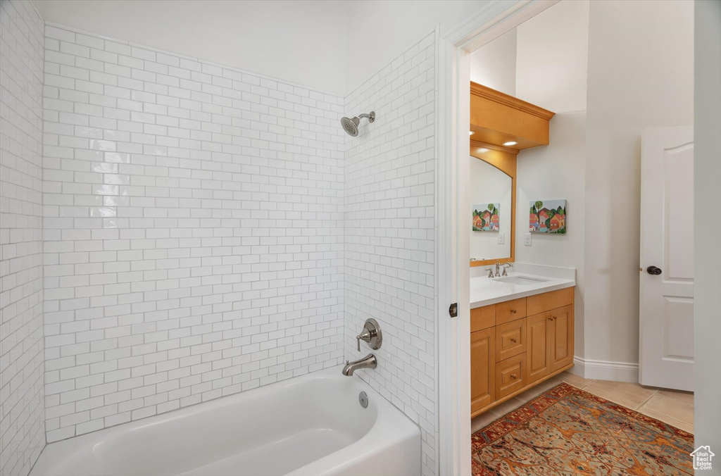 Full bath featuring bathing tub / shower combination, tile patterned flooring, and vanity