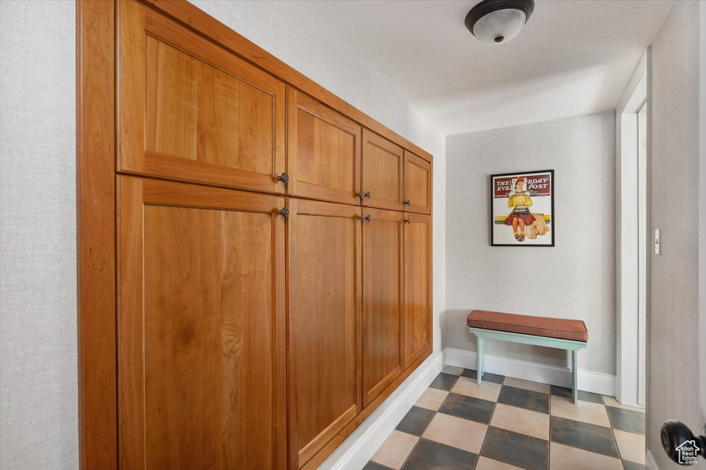 Mudroom with dark floors and baseboards