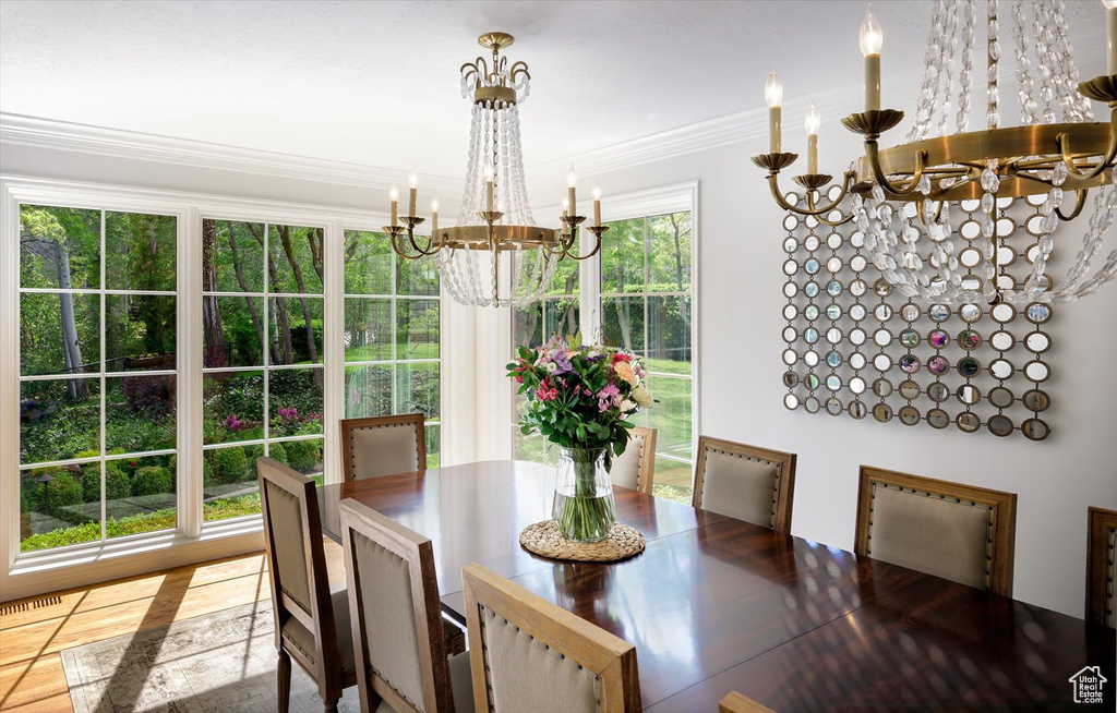 Dining room featuring a chandelier and ornamental molding