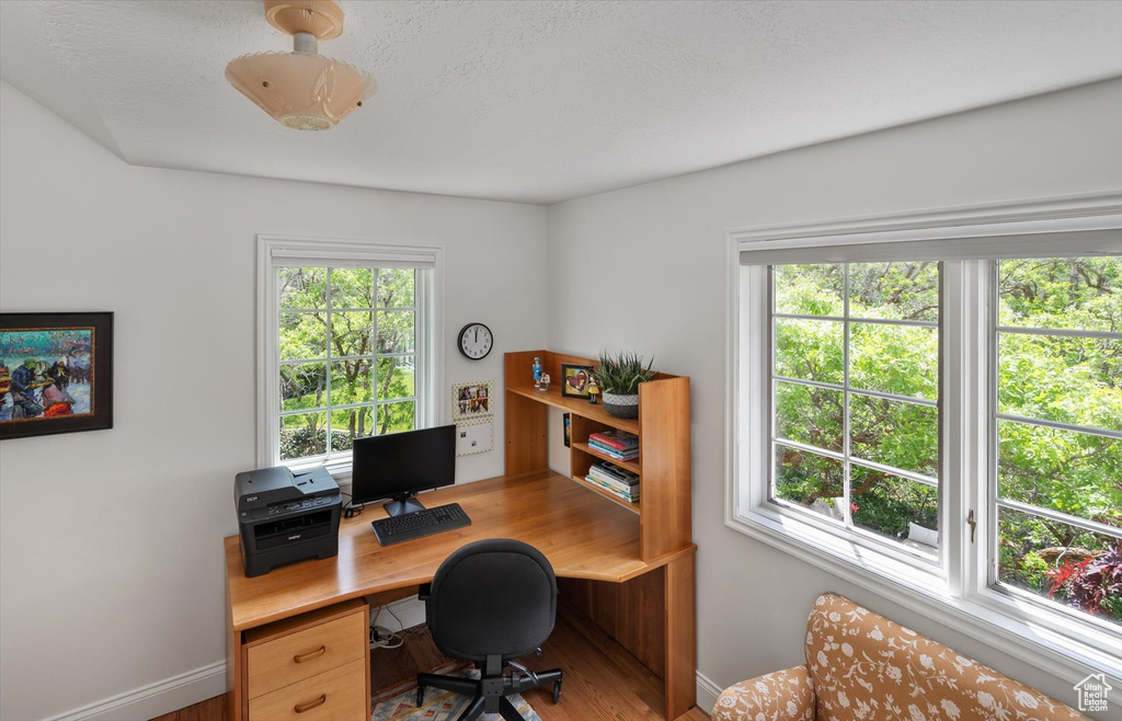 Office space featuring baseboards and wood finished floors