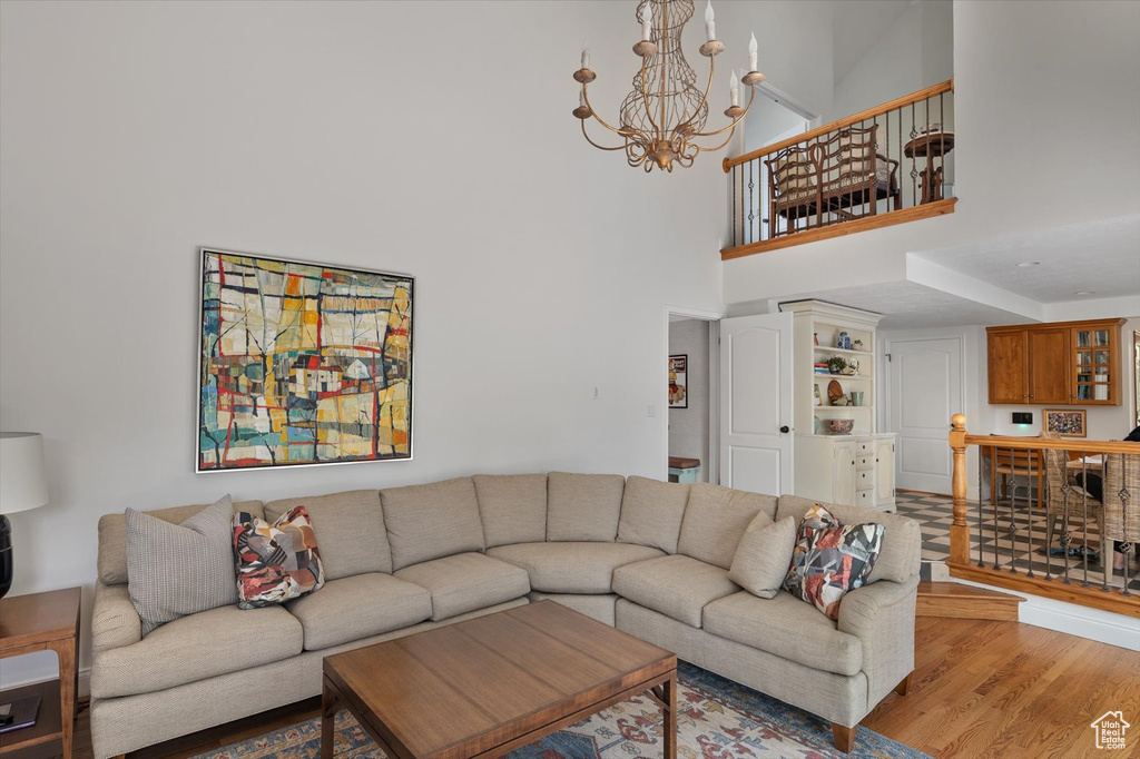 Living area with a chandelier and wood finished floors