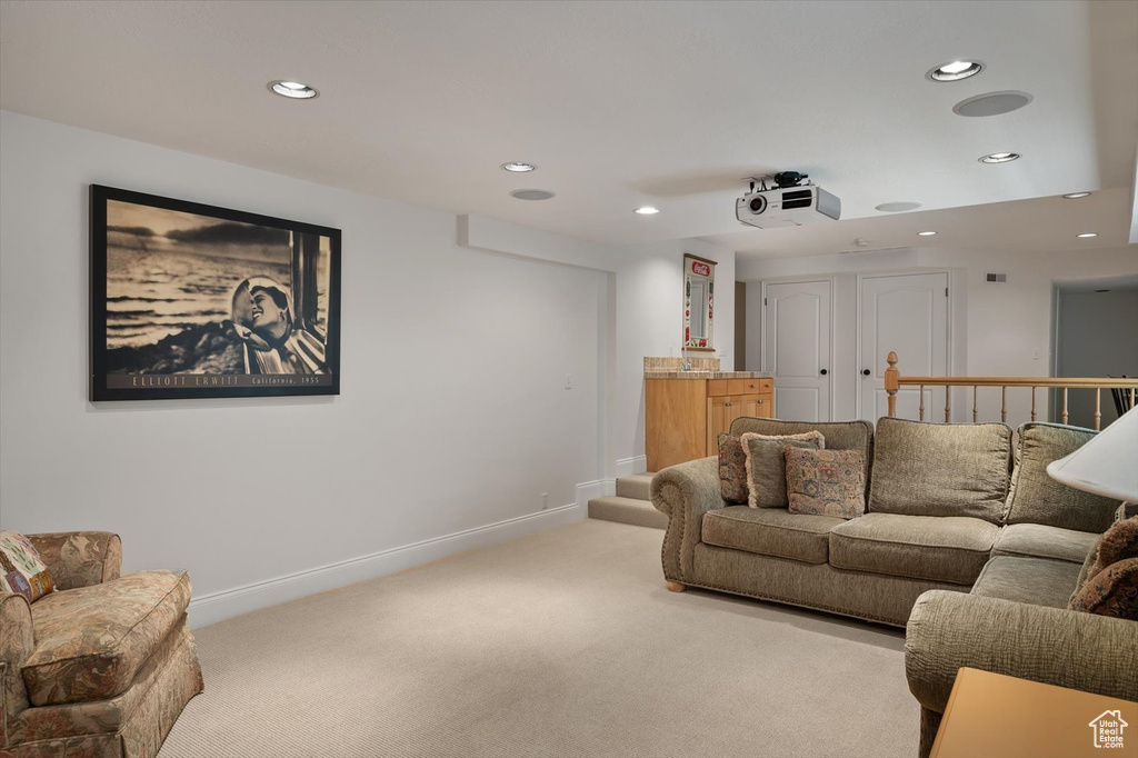 Carpeted living room with recessed lighting and baseboards