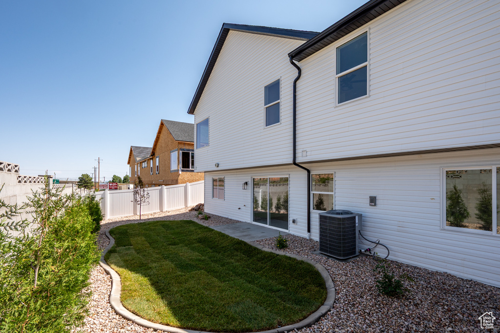 Back of house featuring central air condition unit and a patio area