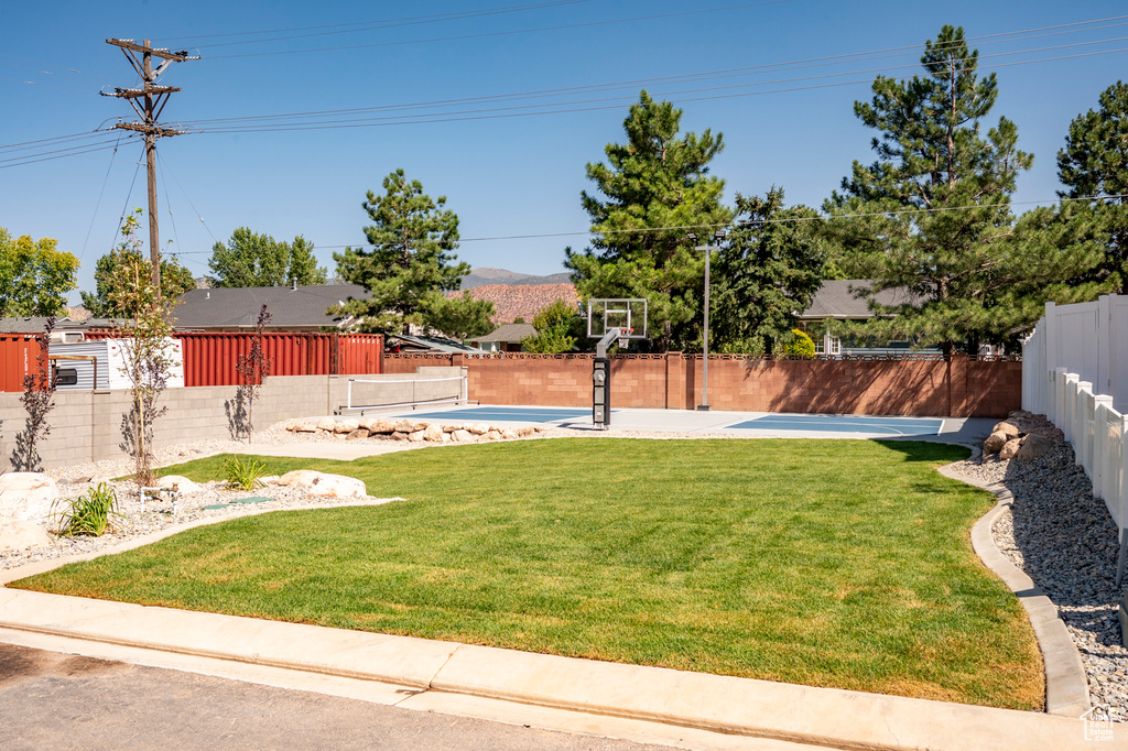 View of yard featuring a swimming pool, basketball court, and a mountain view