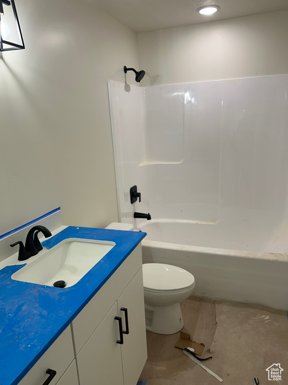Bathroom featuring toilet, vanity, and shower / bathtub combination