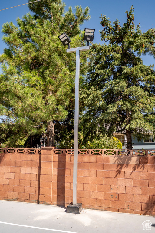 View of basketball court featuring fence