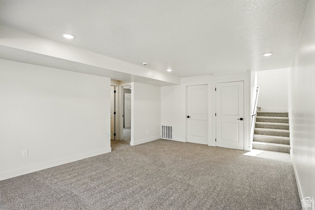 Finished basement featuring carpet flooring, recessed lighting, baseboards, and stairs