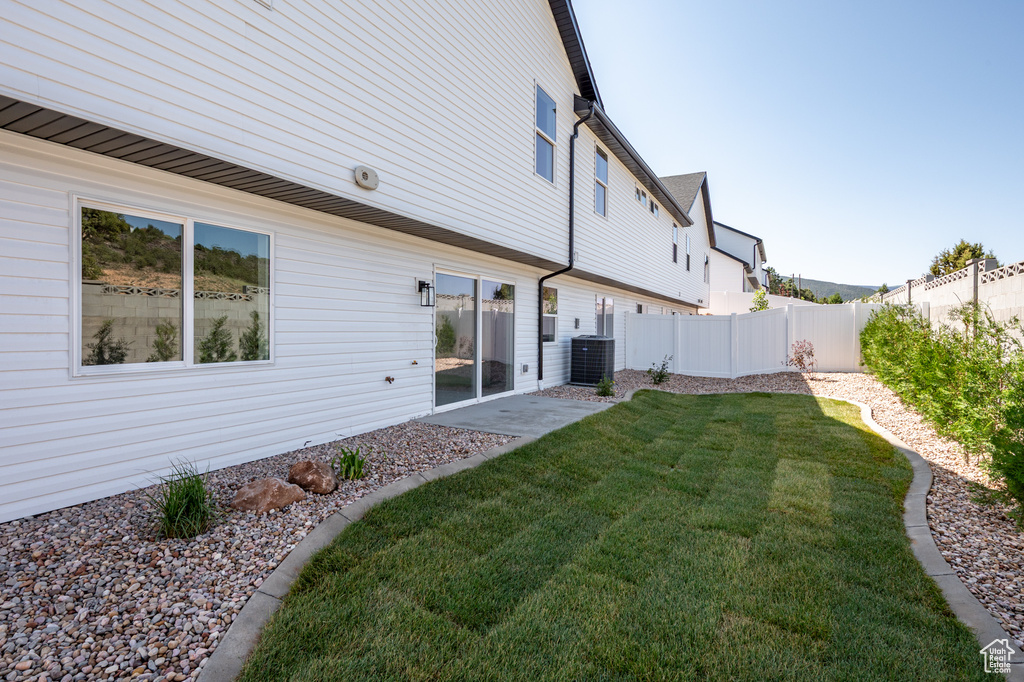 Rear view of house with central AC unit