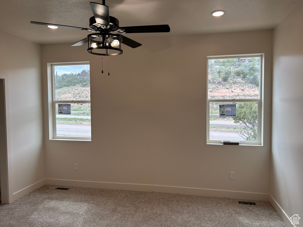 Carpeted empty room with baseboards, ceiling fan, and recessed lighting