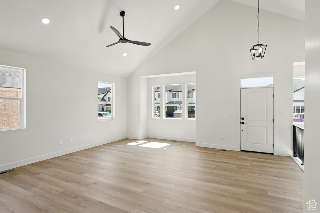 Entryway featuring high vaulted ceiling, a chandelier, light wood-type flooring, ceiling fan, and recessed lighting