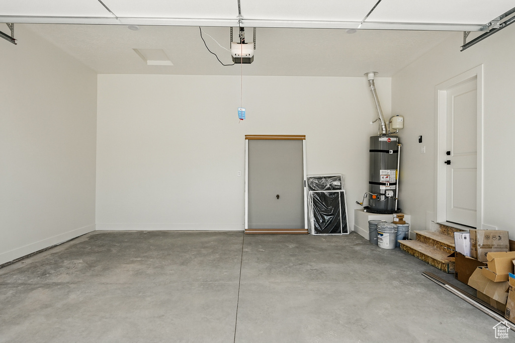 Garage with water heater and a garage door opener