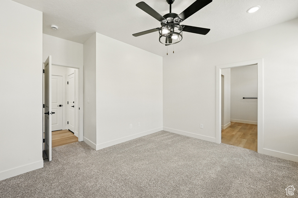 Unfurnished bedroom with carpet floors, baseboards, recessed lighting, and ceiling fan
