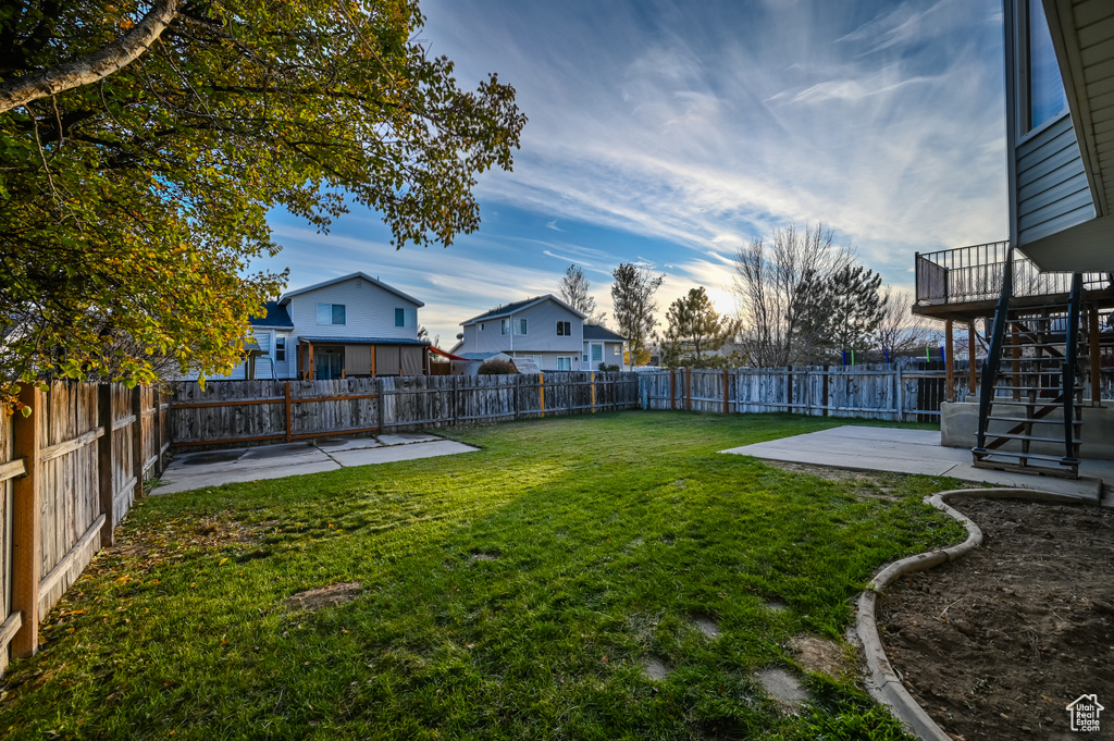 View of yard featuring a patio, stairs, and a residential view