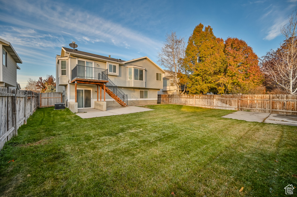 Back of property featuring a patio, stairs, a deck, and cooling unit