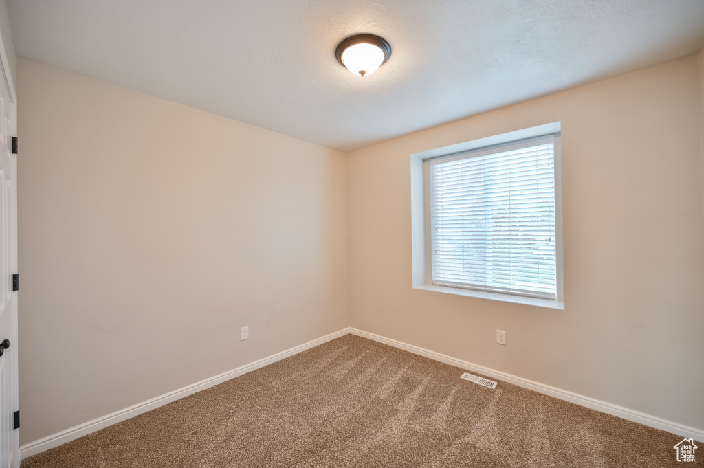 Unfurnished room with carpet flooring and baseboards