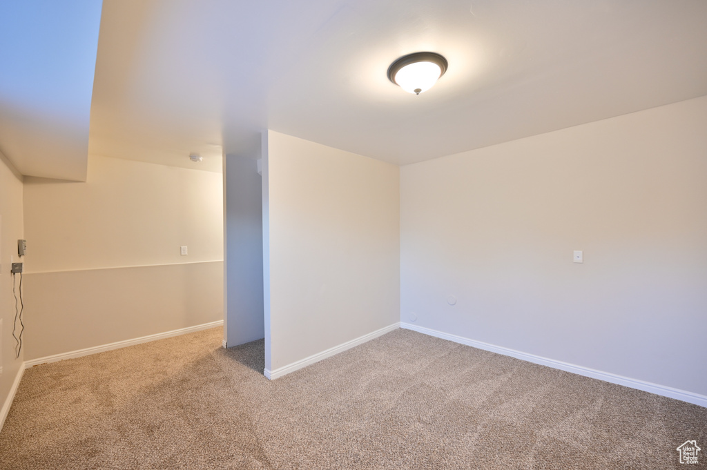 Carpeted spare room with baseboards