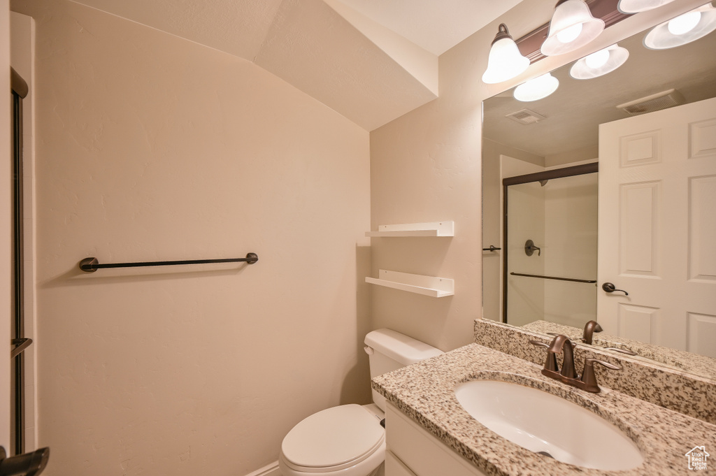Full bathroom with a shower stall, toilet, vanity, and baseboards