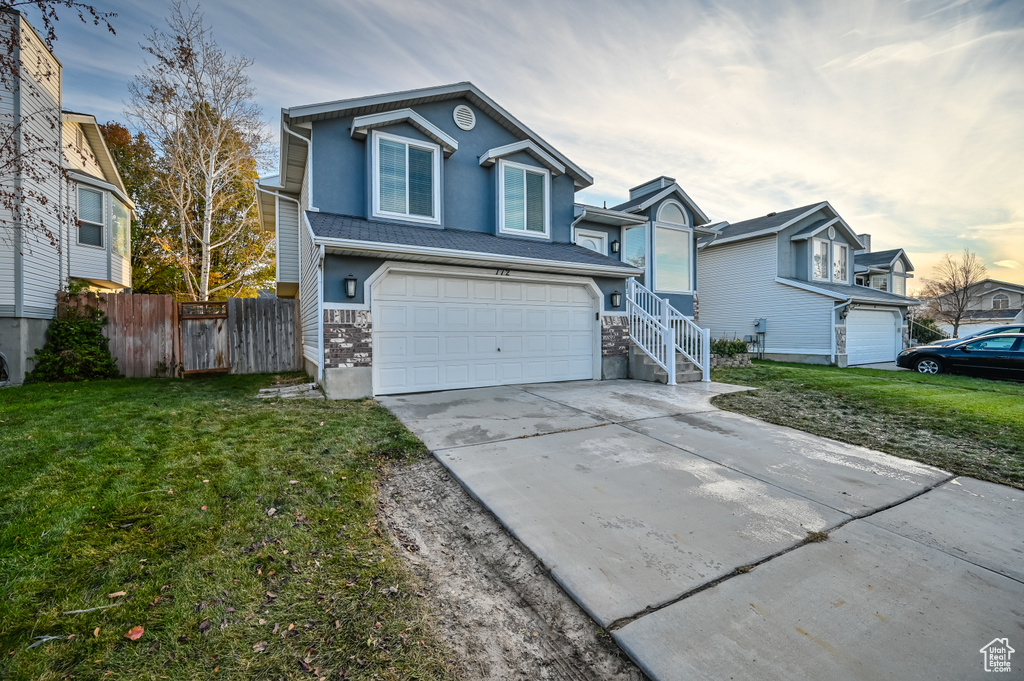 Traditional home with an attached garage and driveway