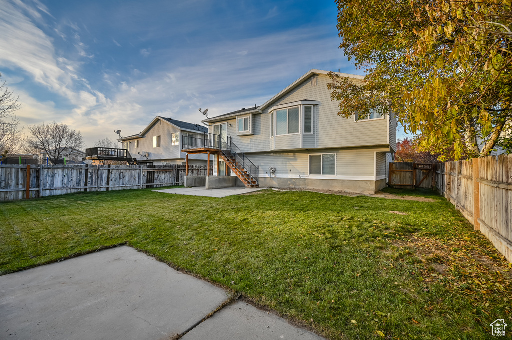 Rear view of property with a patio area and stairs