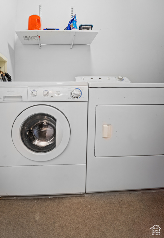 Washroom featuring washing machine and clothes dryer