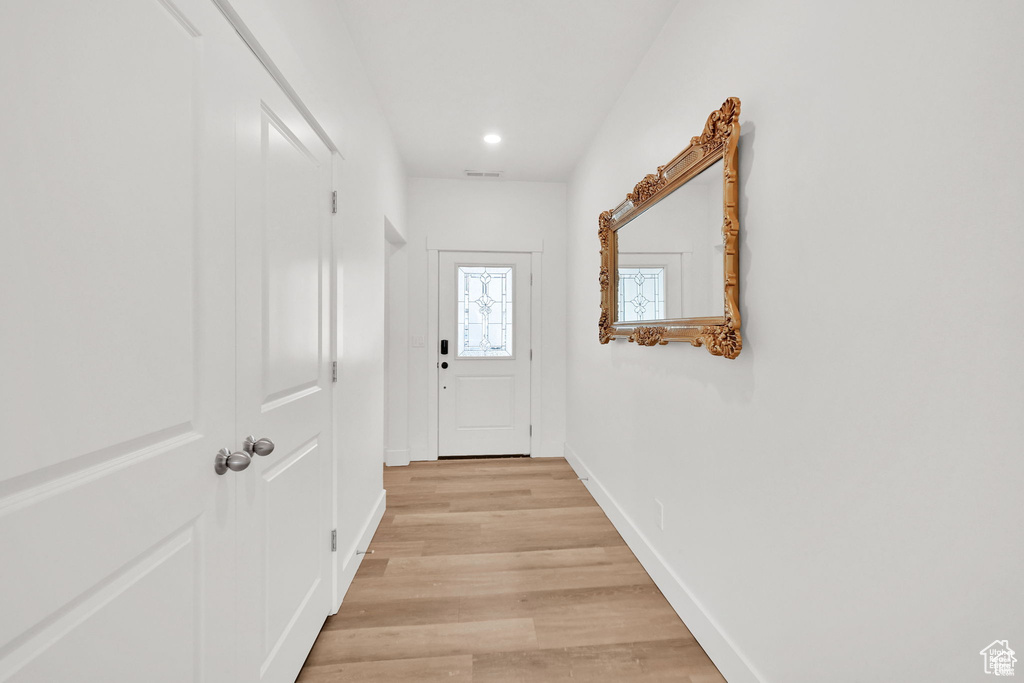 Entryway featuring light wood-type flooring, recessed lighting, and baseboards