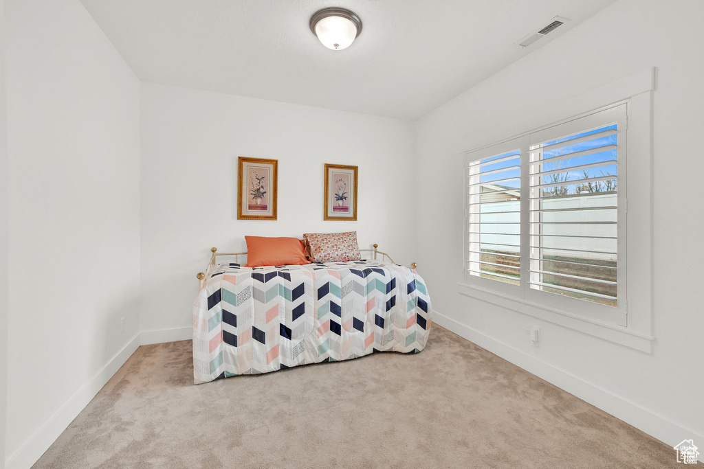 Carpeted bedroom featuring baseboards