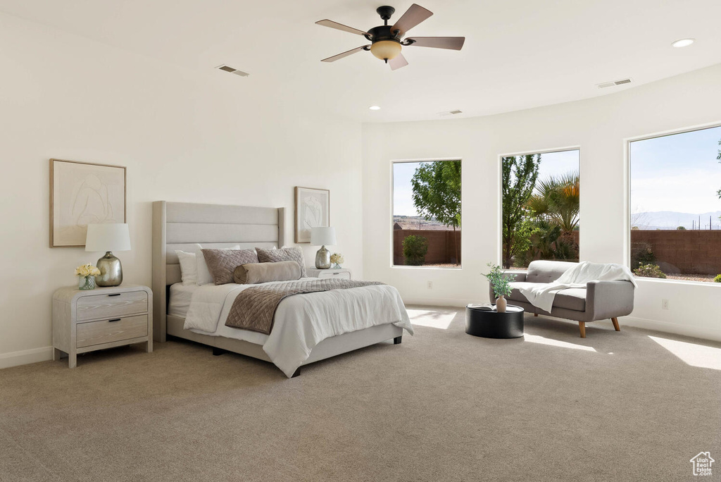 Bedroom featuring light colored carpet, baseboards, recessed lighting, and a ceiling fan
