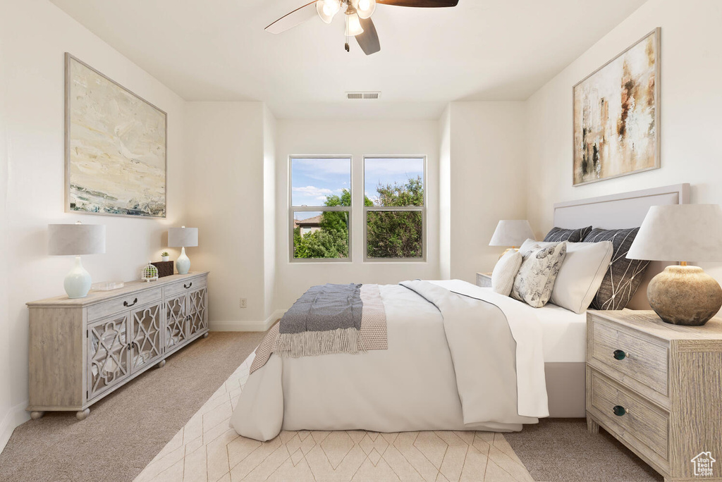 Bedroom with light carpet, a ceiling fan, and baseboards