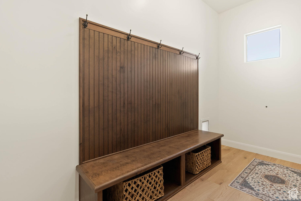 Mudroom featuring baseboards and light wood-style floors