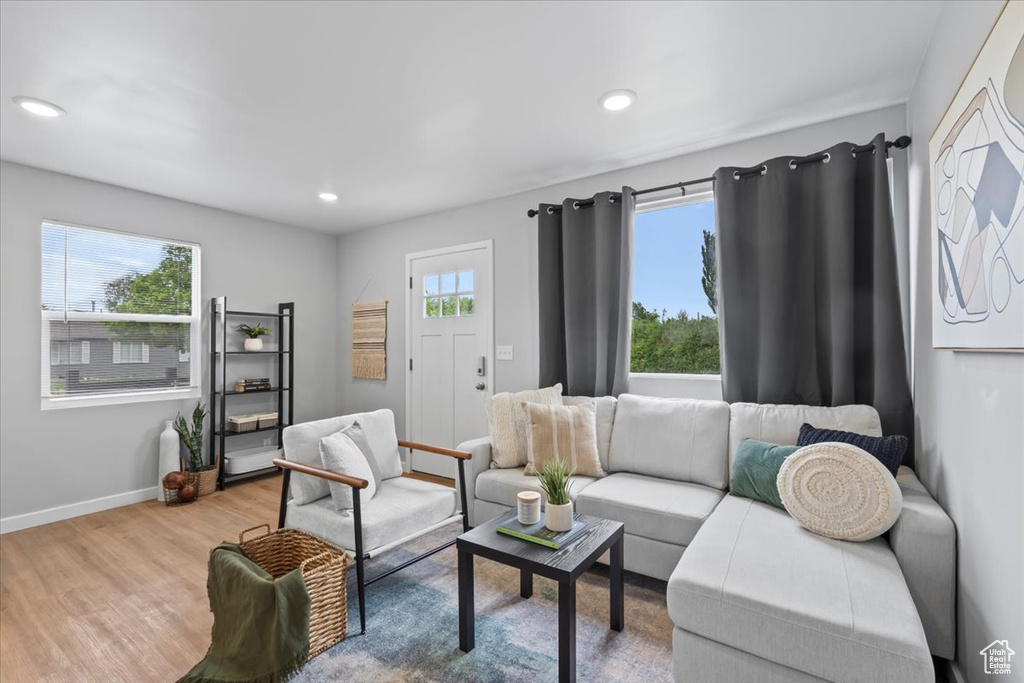 Living area featuring wood finished floors, baseboards, and recessed lighting