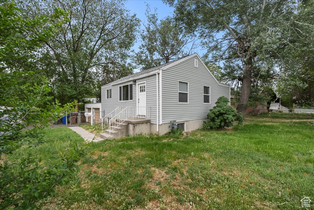 View of property exterior featuring a yard