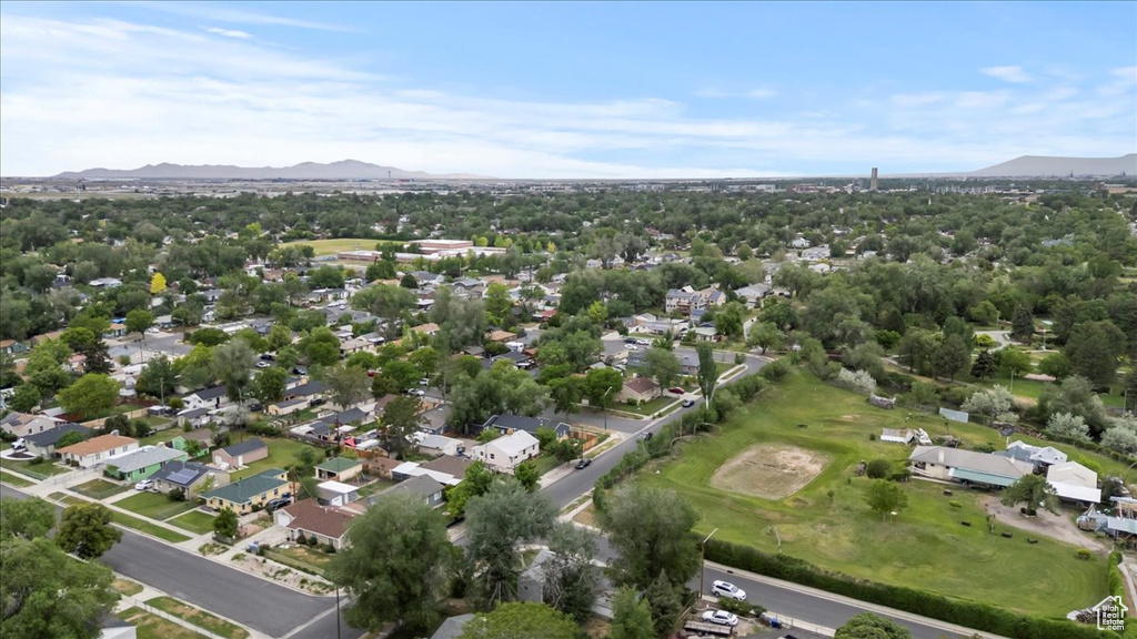 View of property location featuring a mountainous background, nearby suburban area, and a local golf course