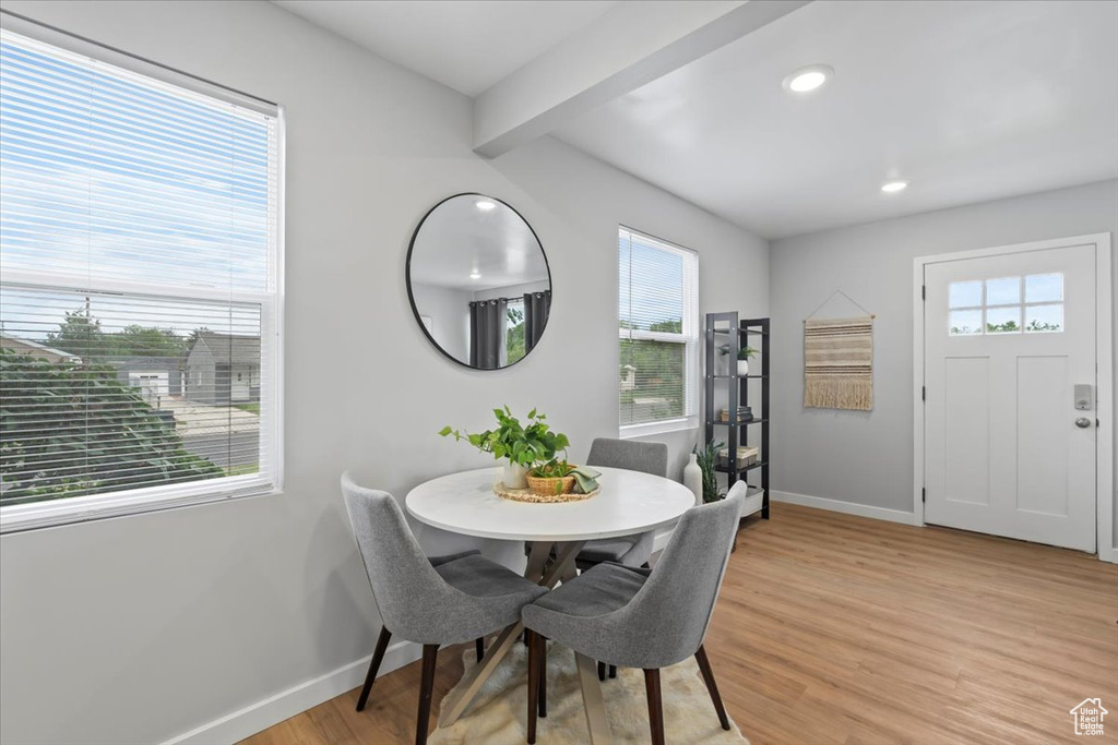 Dining room featuring baseboards, plenty of natural light, light wood finished floors, beam ceiling, and recessed lighting