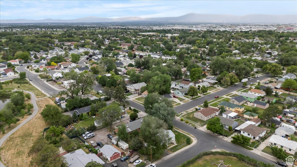 Aerial overview of property's location with a mountainous background and nearby suburban area