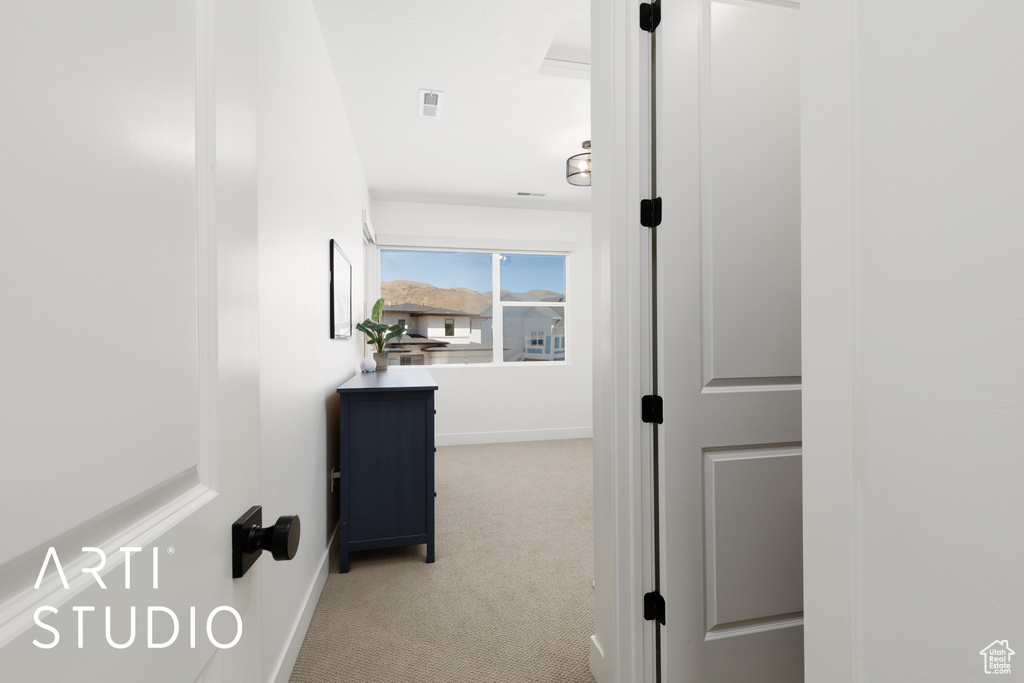 Hall featuring baseboards and carpet