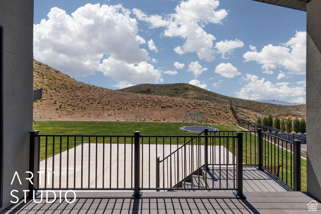 Wooden deck with a lawn and a mountain view