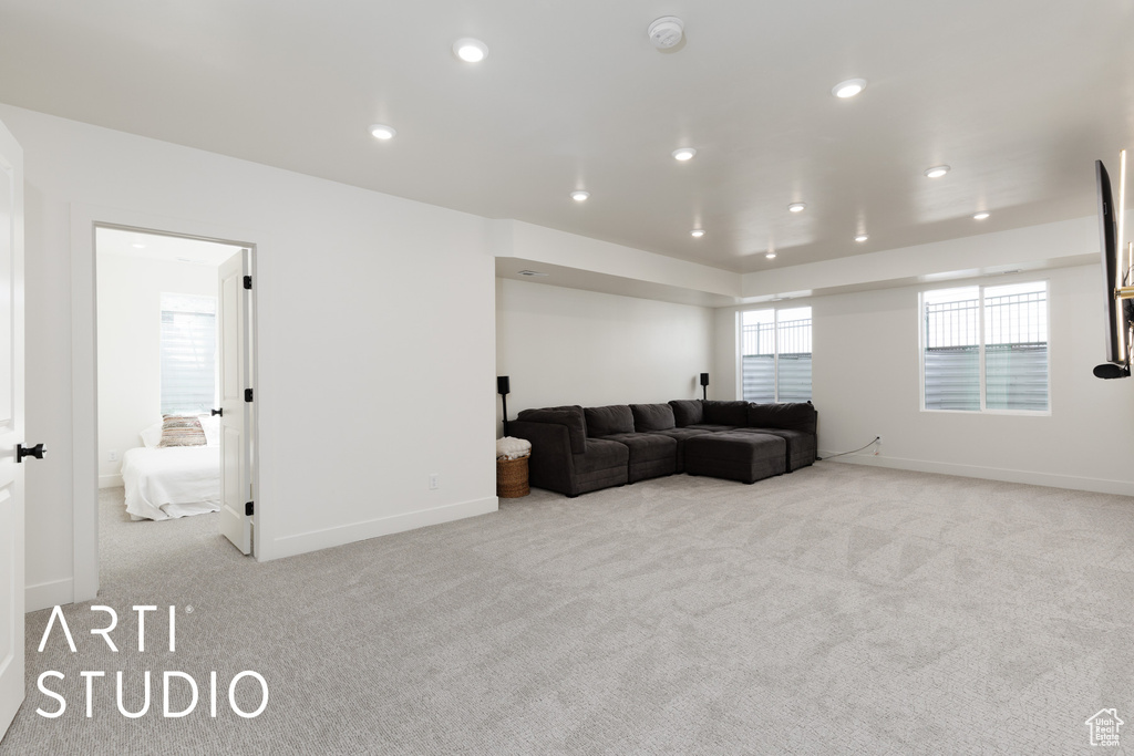 Living area featuring carpet floors, recessed lighting, and baseboards