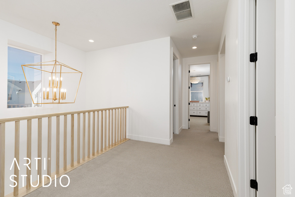Hall featuring visible vents, baseboards, an inviting chandelier, carpet flooring, and recessed lighting
