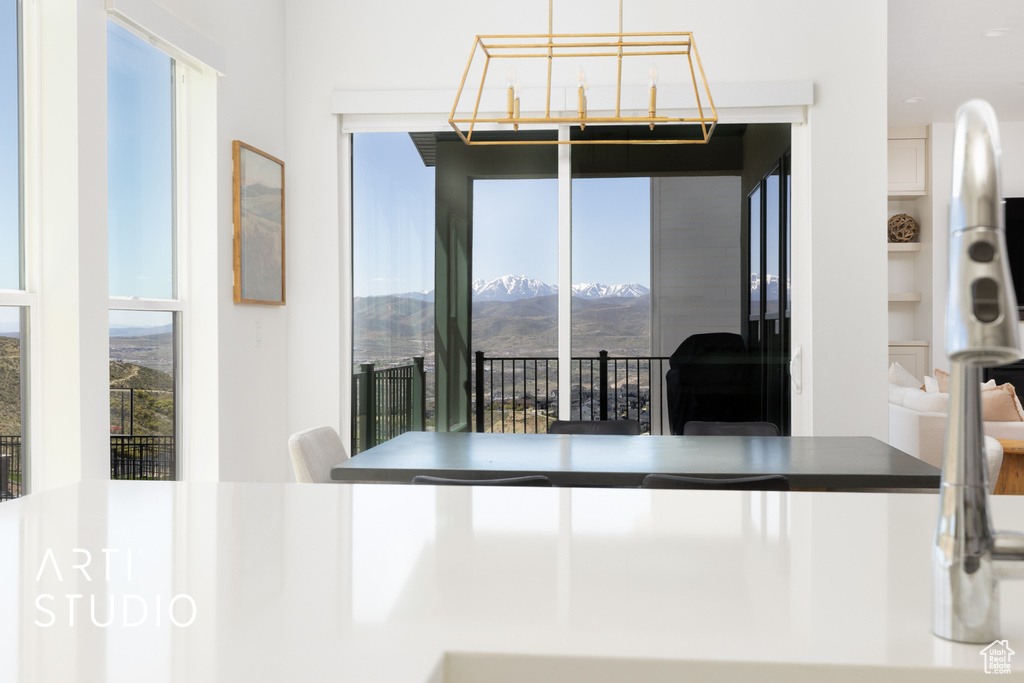Dining room featuring a mountain view, a wealth of natural light, and built in features