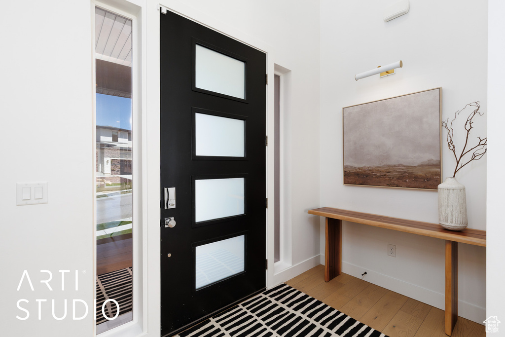 Foyer with baseboards and light wood-style floors