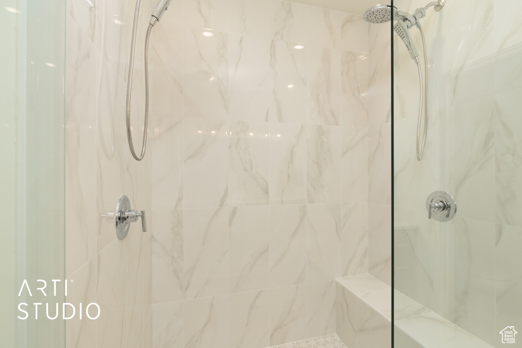 Bathroom featuring a marble finish shower