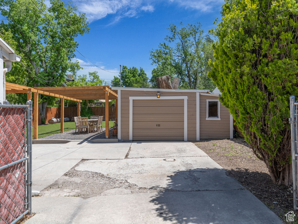 Garage with driveway and fence