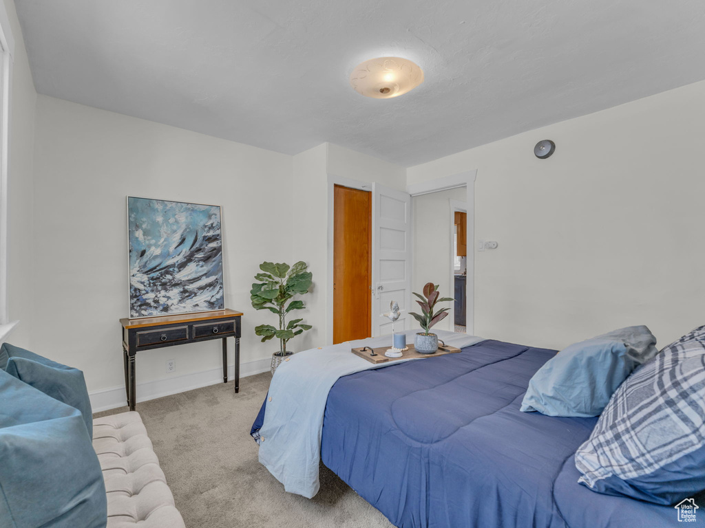 Carpeted bedroom featuring baseboards