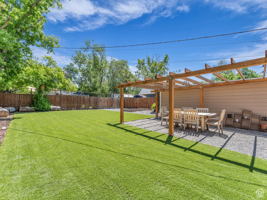 View of yard with a pergola and a patio area