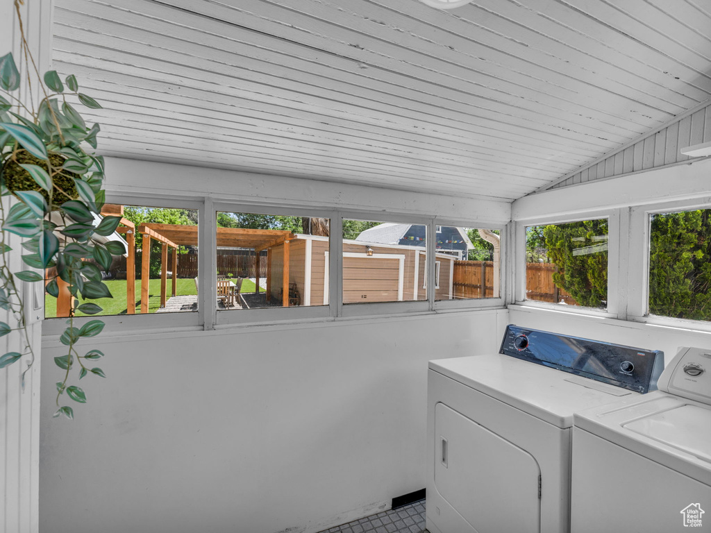 Laundry area featuring washer and dryer, healthy amount of natural light, and wooden ceiling